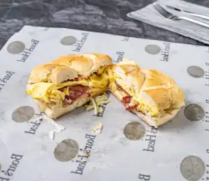 A sandwich cut in half on top of a paper.