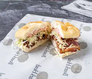 A sandwich cut in half on top of a paper.