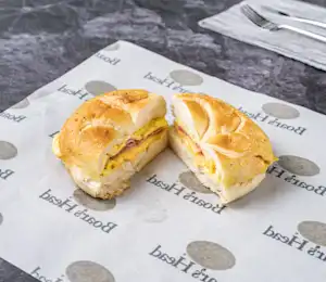 A sandwich cut in half sitting on top of a paper.